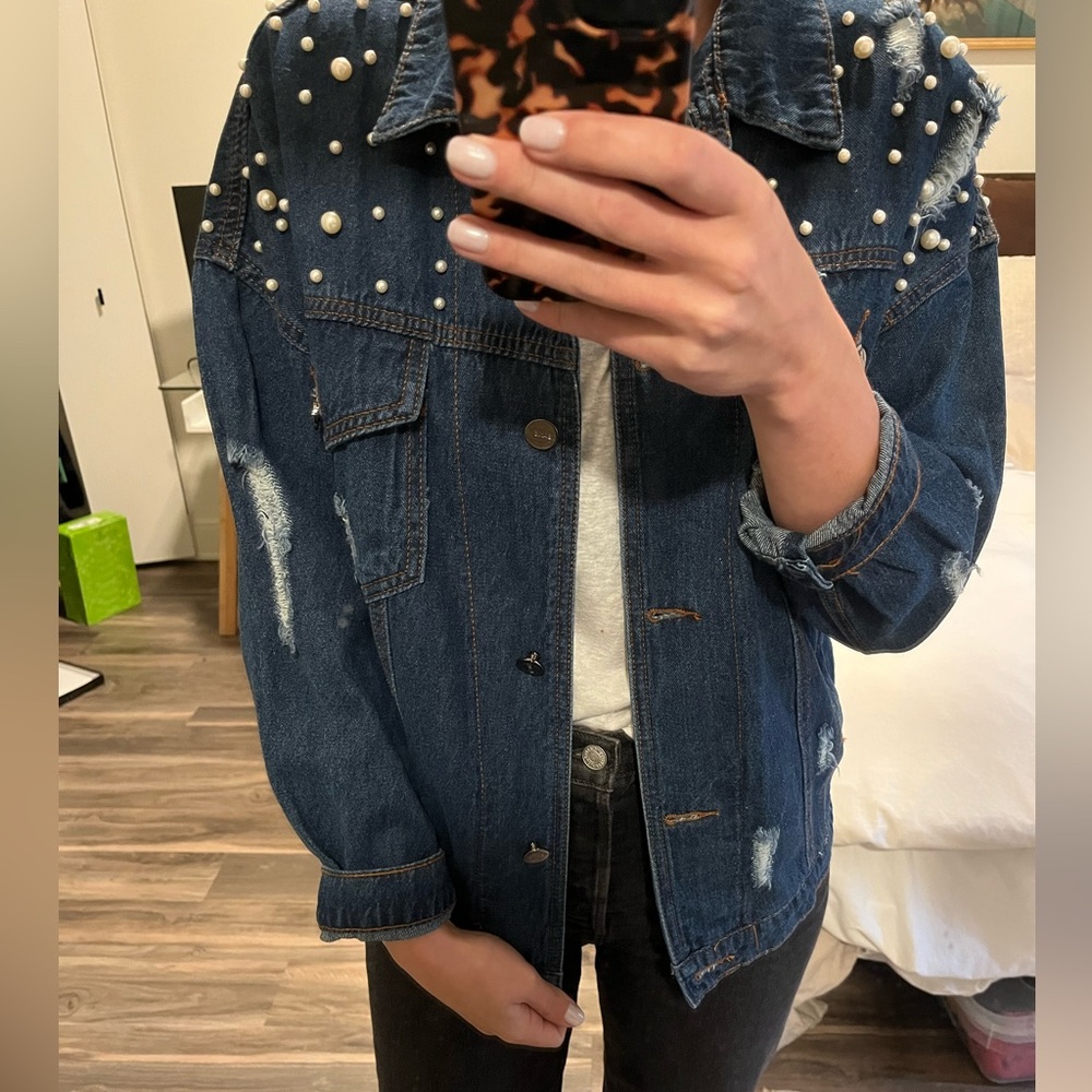Perfectly worn blue Jean jacket with shoulder pearls.